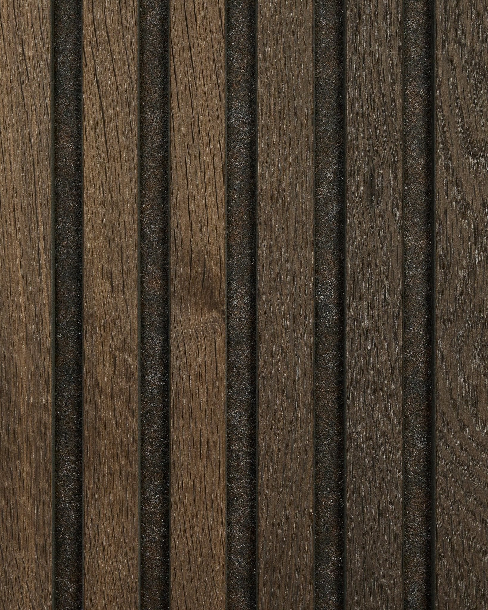 Close-up of Akupanel acoustic wood panel sample in Smoked Oak by WoodUpp, featuring natural brown grain, vertical grooves, and evenly spaced dark lines.