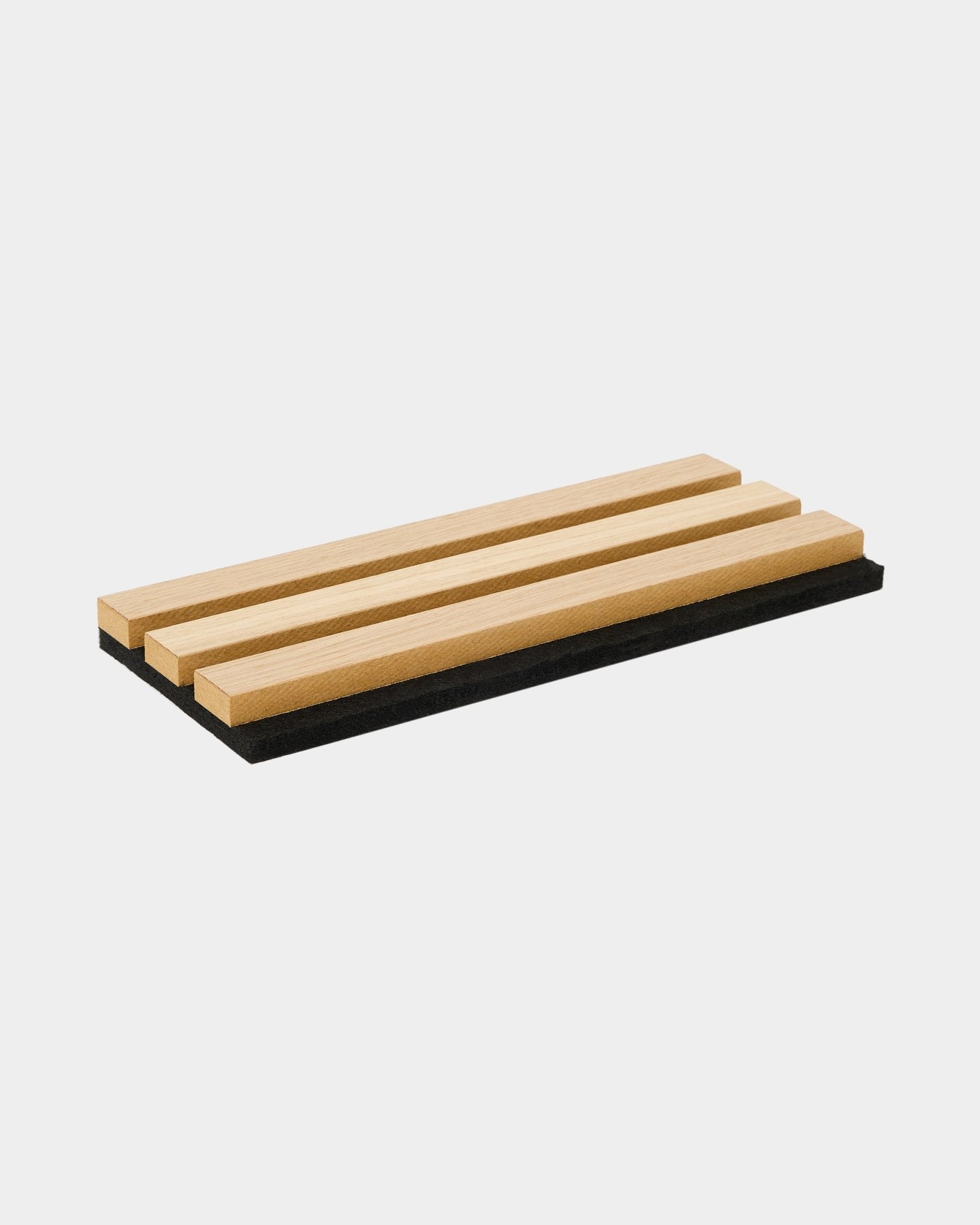 WoodUpp Akupanel sample tray in Classic Oak features three acoustic wood slats on a black felt base, showcasing Nordic design and material contrast.