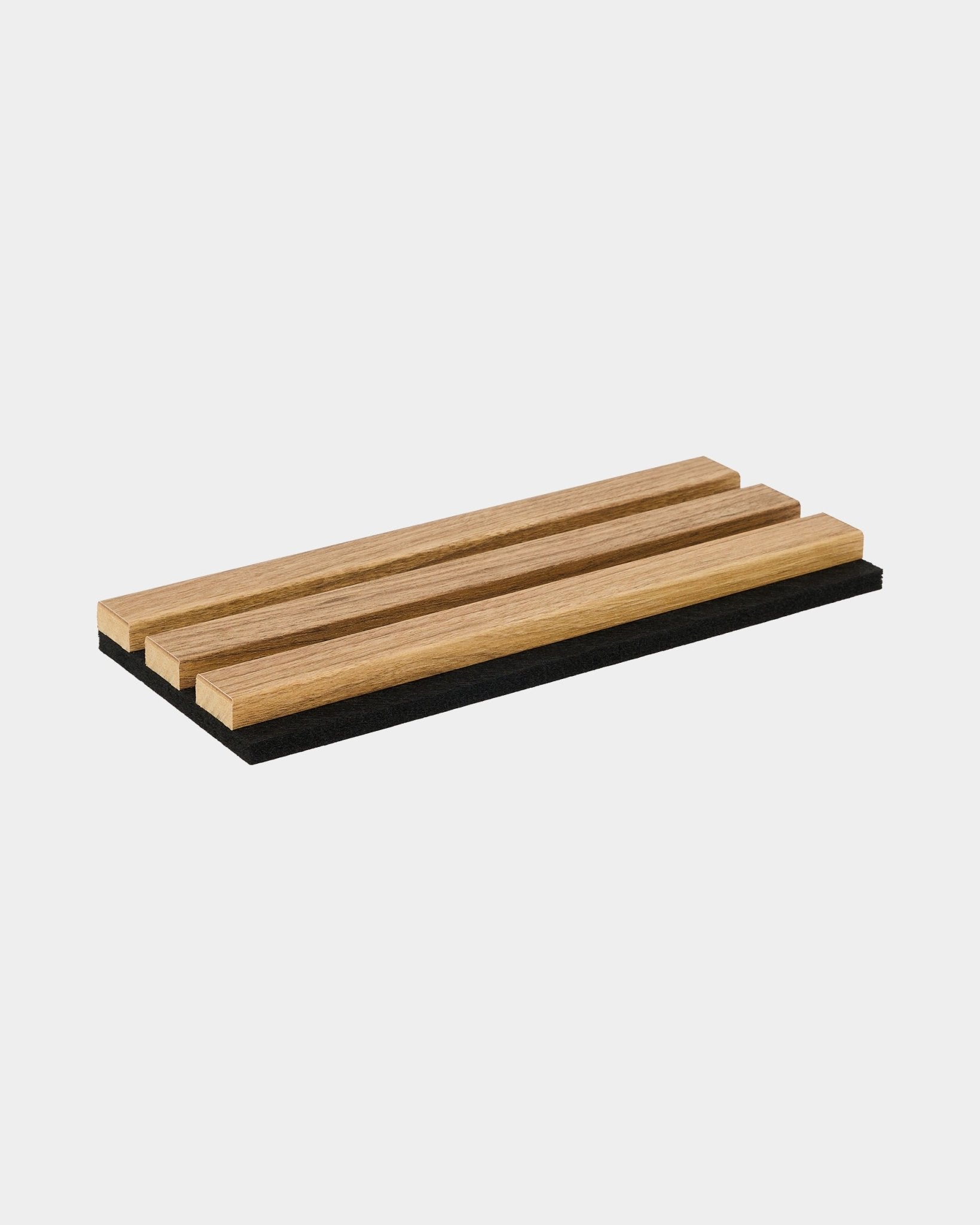 WoodUpp Essential English Oak sample tray with three wood slats set on a black base, illustrating Nordic style and material finish for acoustic panels.