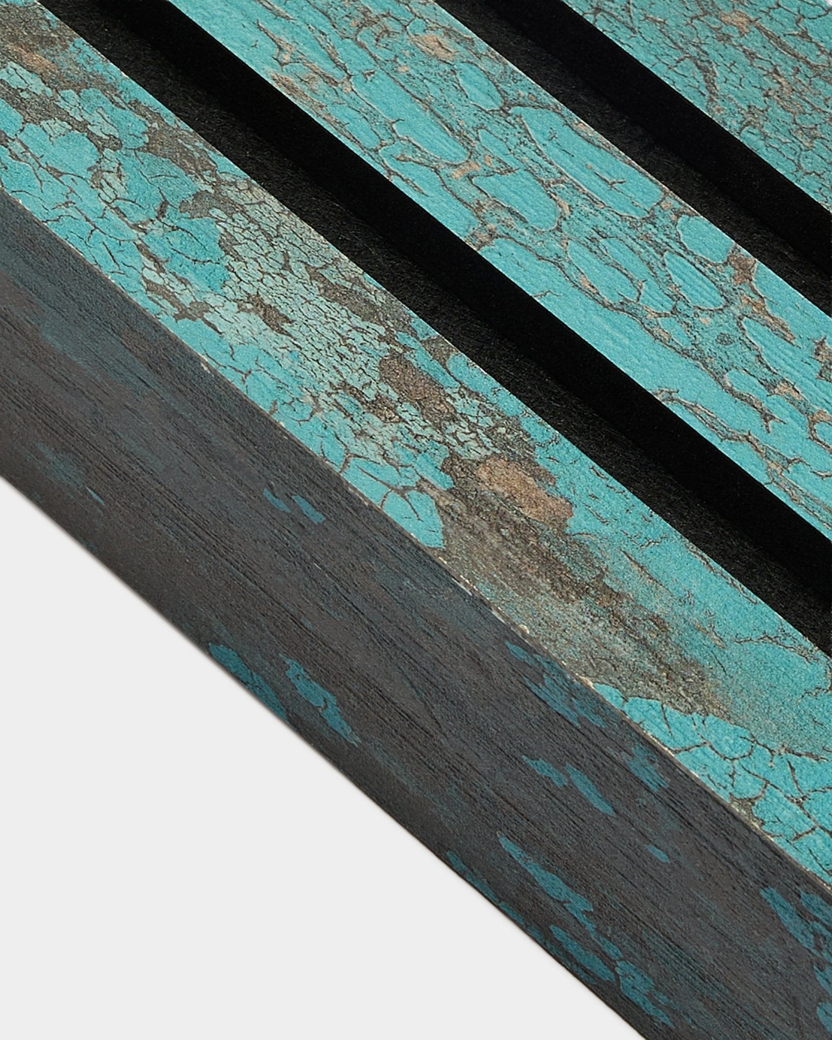 Close-up of WoodUpp Akupanel end lamella in Oxide Blue, 6.7 cm wide, featuring cracked blue paint and black grooves on a rustic acoustic panel surface.
