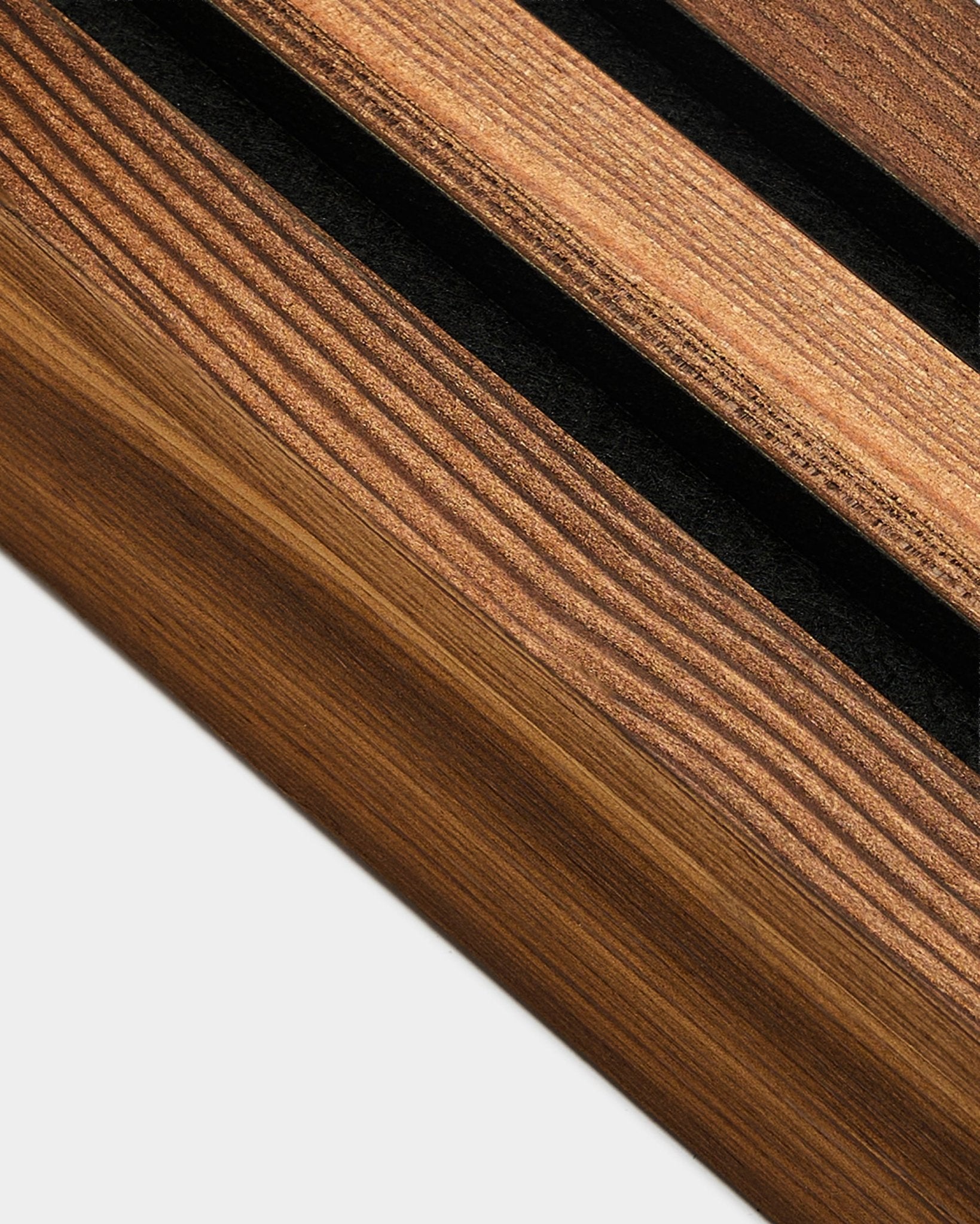 Detailed view of WoodUpp end lamella in Rustic Smoked Larch, 6.7 cm, designed for finishing Akupanel acoustic panel edges on light-colored walls.