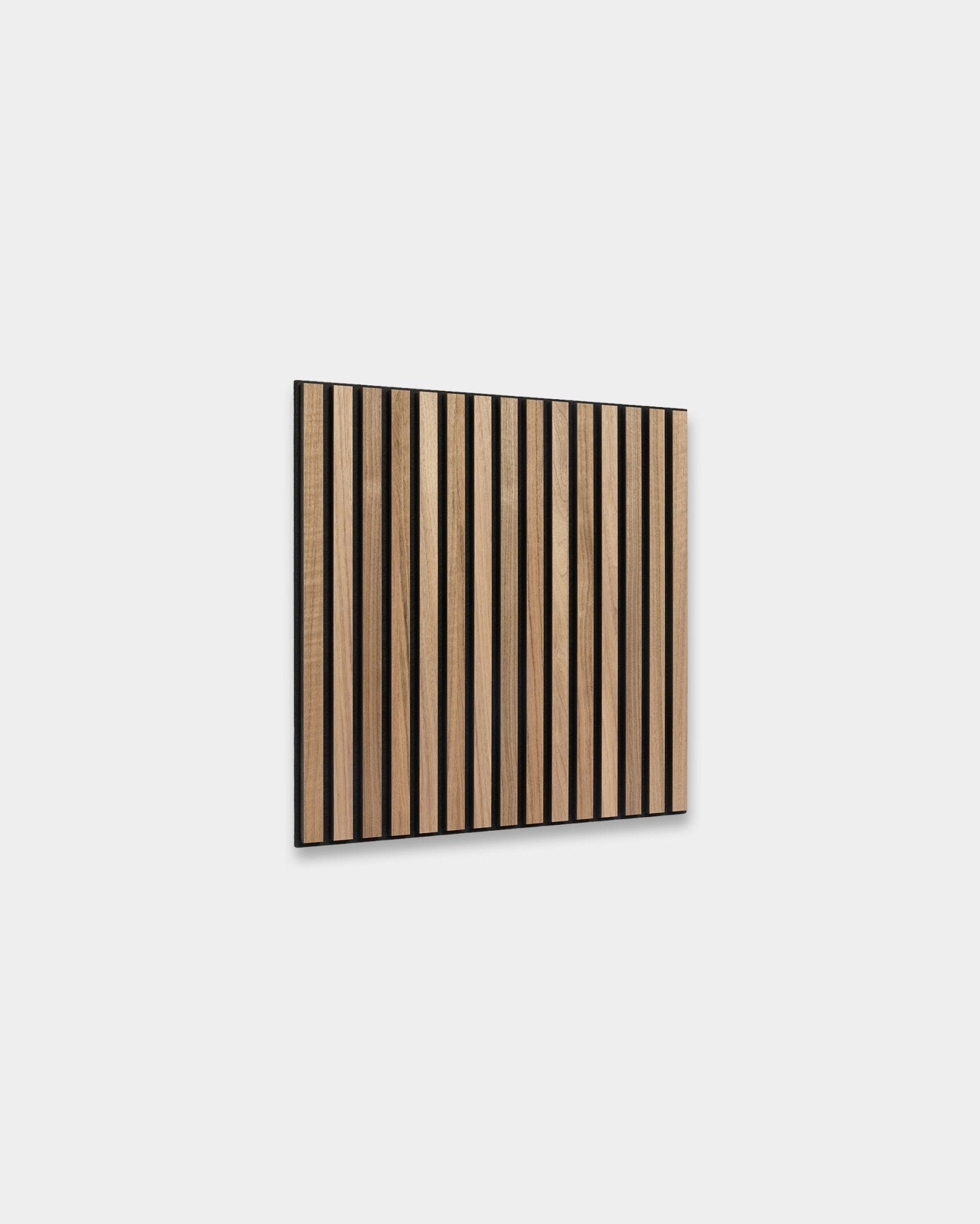 WoodUpp Akupixel acoustic panel in walnut, 60x60 cm, features evenly spaced walnut slats with black gaps mounted on a light gray wall for Scandinavian design.