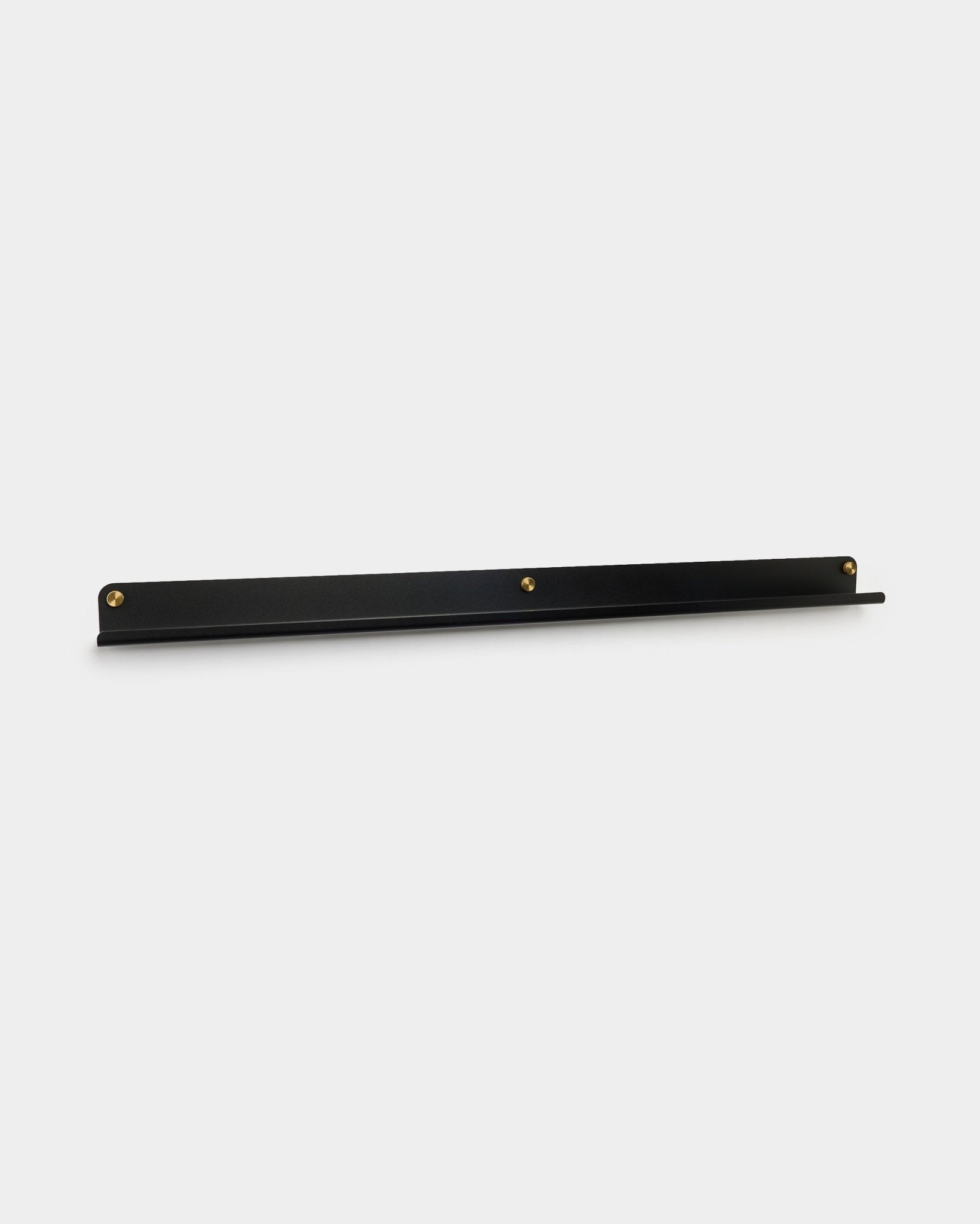The Norr Narrow Shelf in black by WoodUpp, 115.9 cm, wall-mounted with three brass thumbscrews, shown against a plain white background.