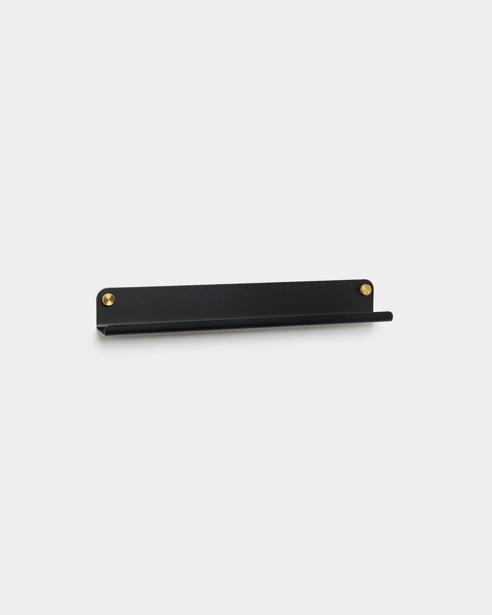 The Norr narrow black steel shelf, 51.9 cm, by WoodUpp with brass screws, minimalist design, displayed against a plain light gray background.