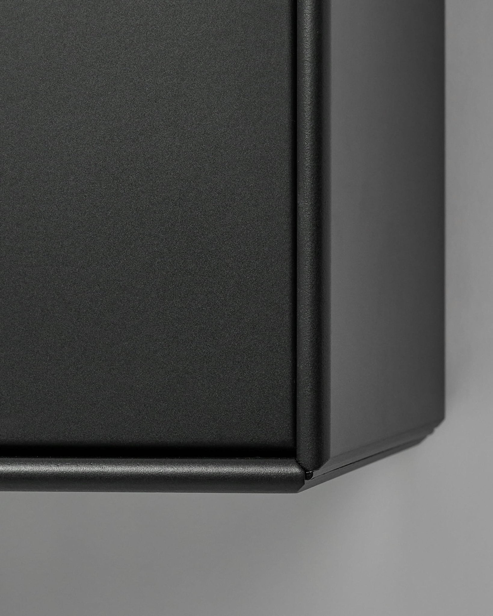 Arka TV Console by WoodUpp in matte black metal, shown close-up against a light gray background. Nordic design complements acoustic wood panel collections.
