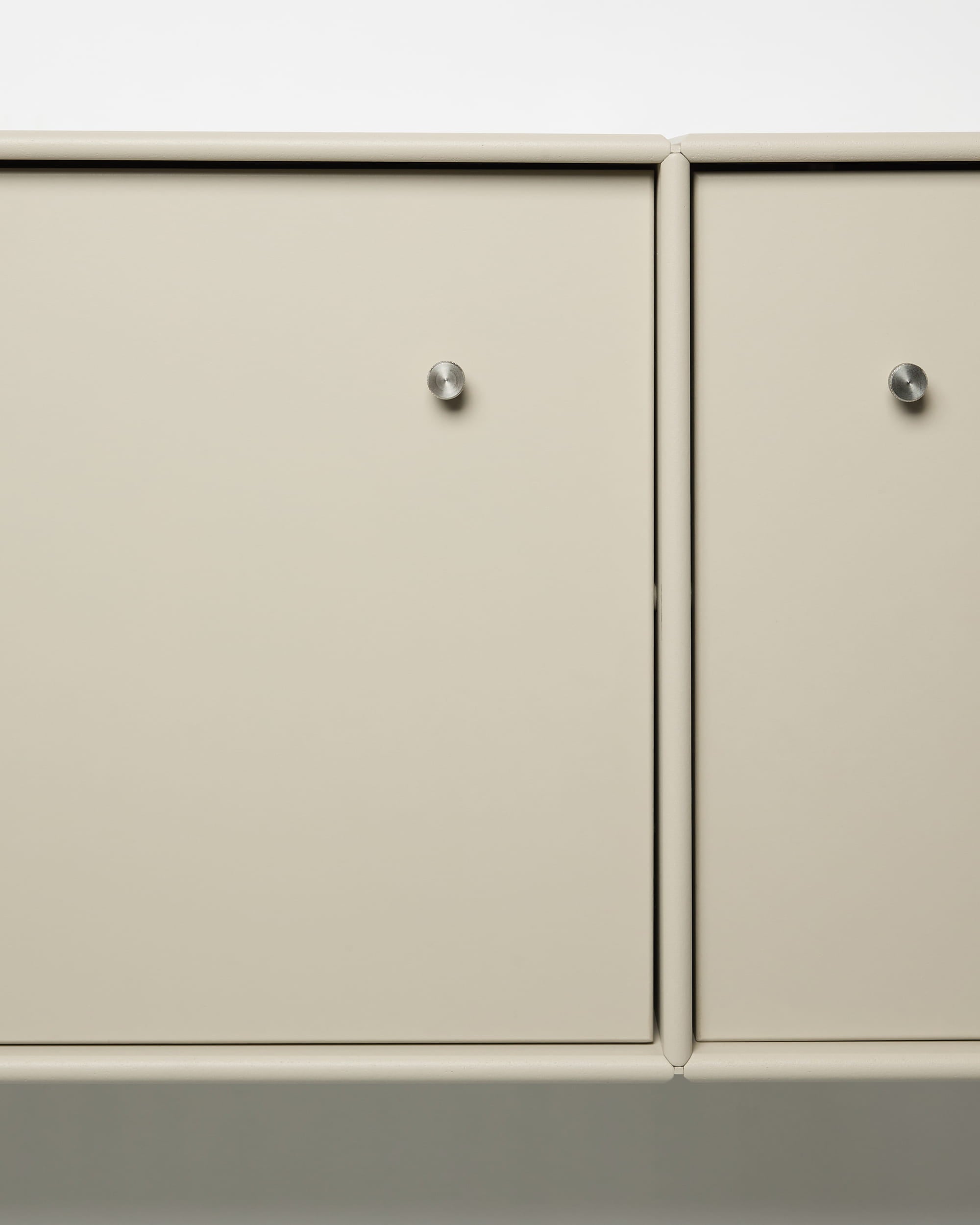 Arka TV Console by WoodUpp with beige metal cabinet doors, round silver knobs, modular design, and integrated cable management for Nordic interiors.