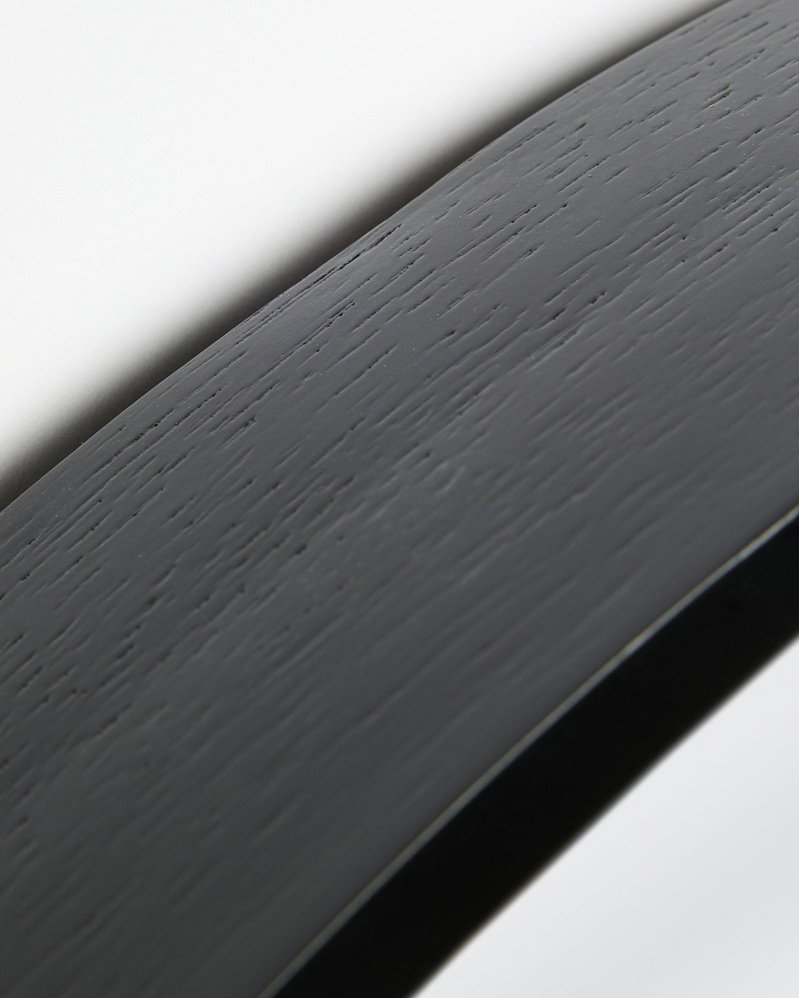 Close-up of the Linn | Mirror / Black Oak acoustic panel by WoodUpp, featuring a curved black oak surface and frame set against a white background.