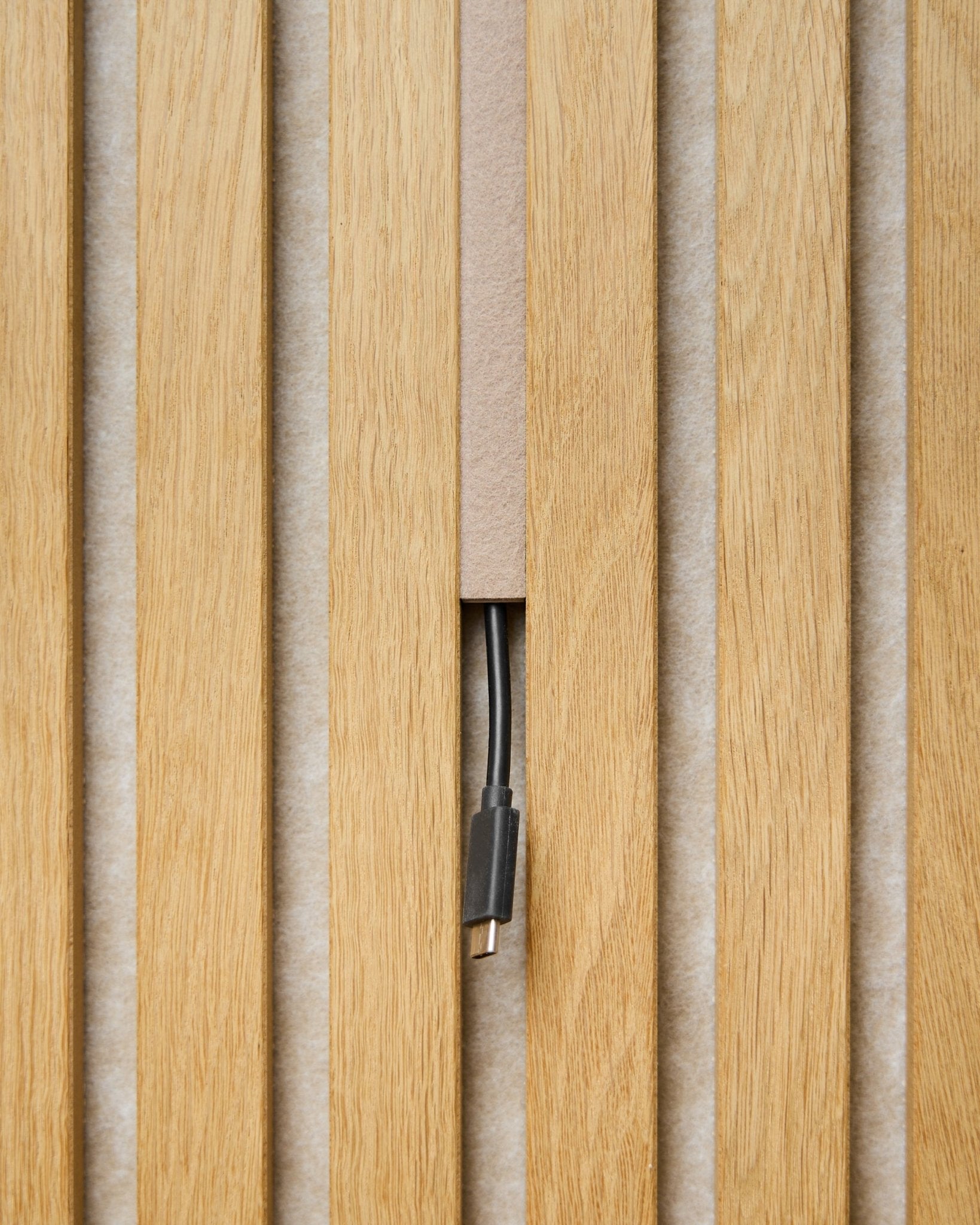 Dupps Pop-on Cable Cover (beige, set of 3) by WoodUpp conceals cables between acoustic panel slats, leaving only the connector visible for a streamlined finish.