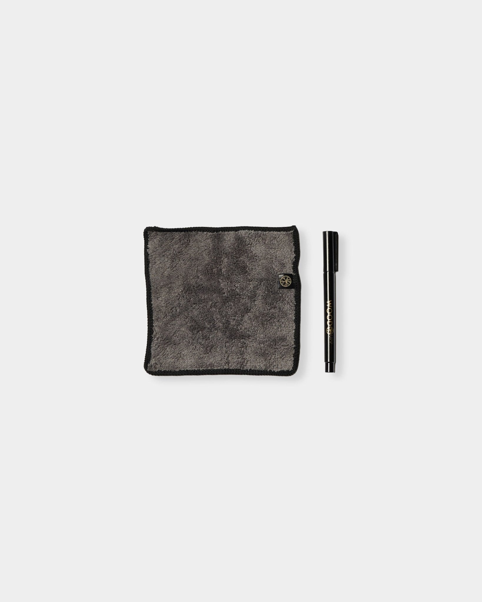 The Norr Blackboard set by WoodUpp features a gray microfiber cloth with black edges and a chalk ink marker, designed for use on magnetic acoustic panels.