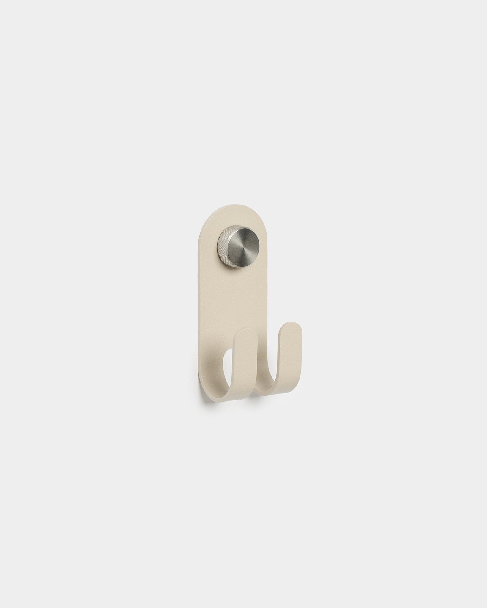 WoodUpp Norr Double Hanger in beige with two metal hooks and a circular silver knob, minimalist Nordic design, displayed on a plain white background.
