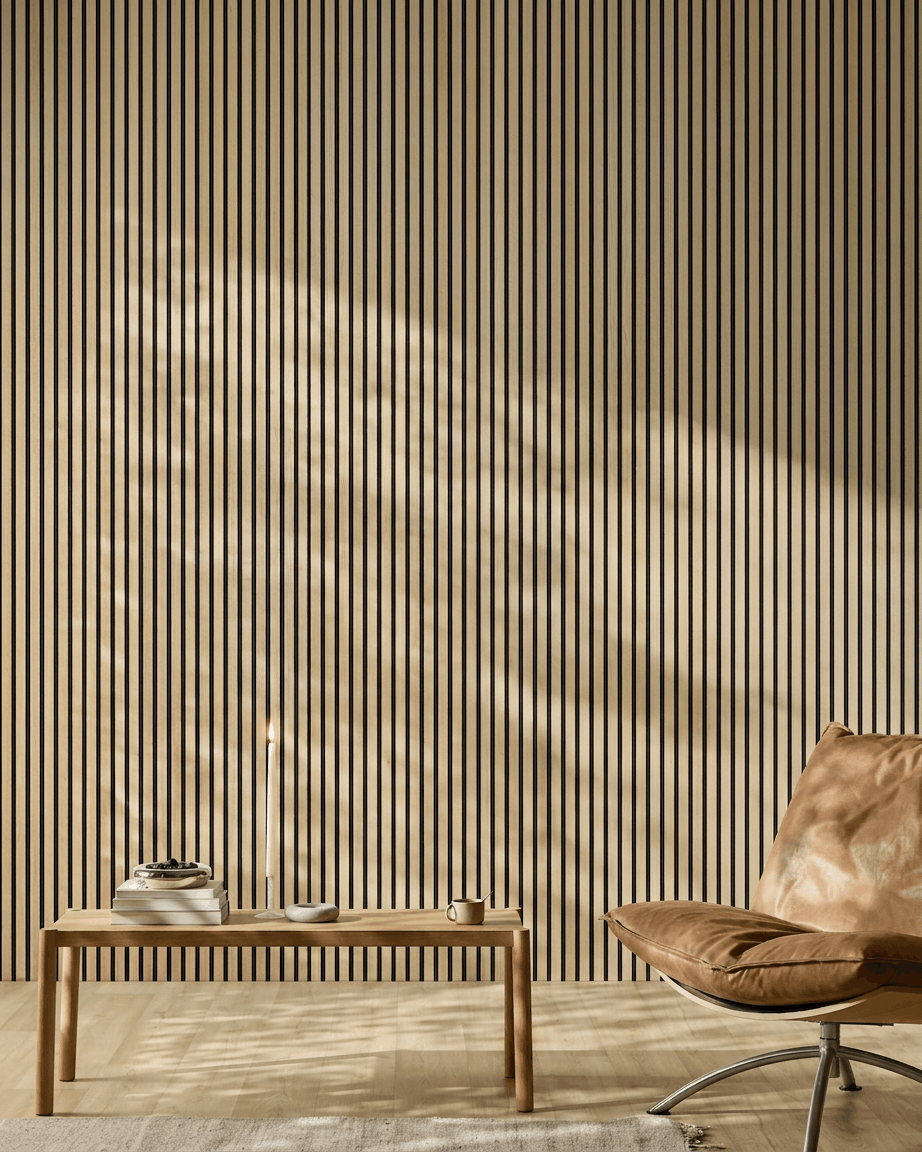 Minimalist room featuring a WoodUpp Akupanel acoustic wood panel in Classic Oak, leather chair, wooden table, candle, and sunlight casting shadows.