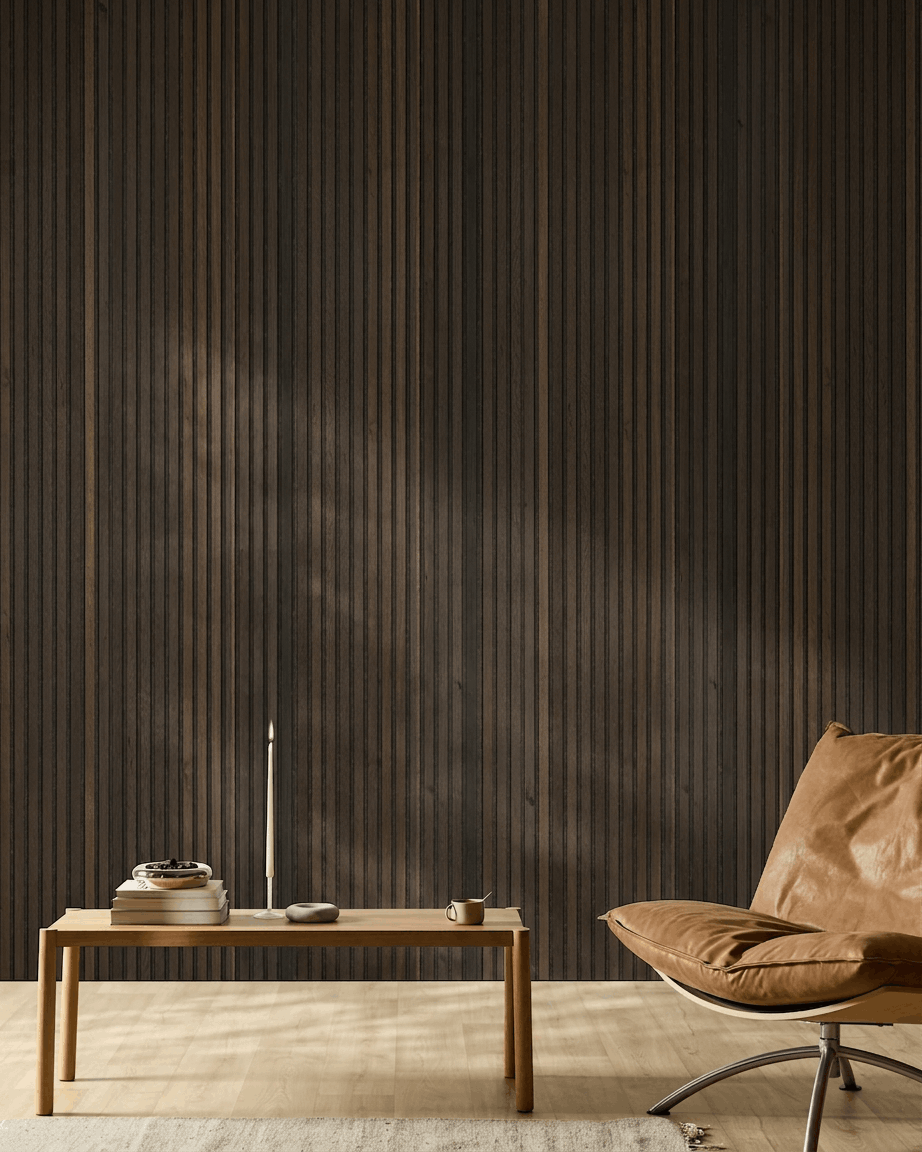 Minimalist Nordic room with tan leather chair, wood table, candle, and cup set against a WoodUpp Akupanel Natural Wood Rustic Smoked Oak acoustic panel wall.