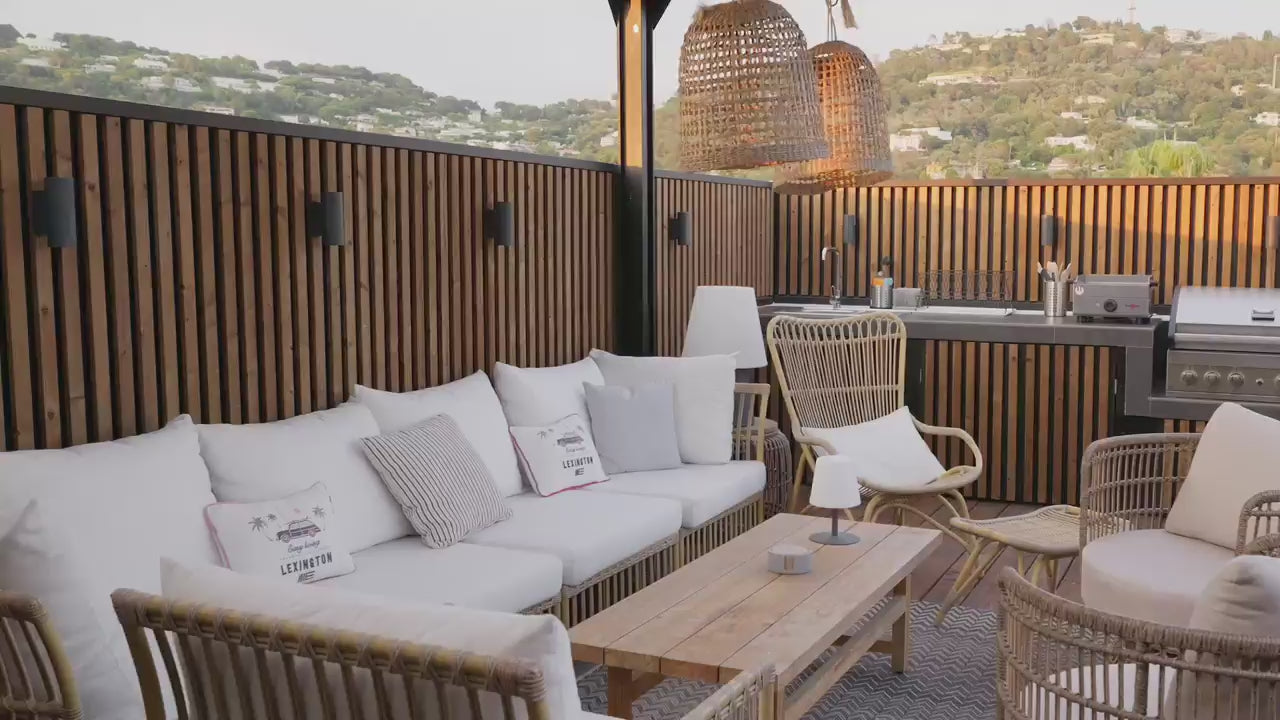 A tour of the Cannes rooftop terrace: vertical Aluwood panels wrapping the parapet, the screen and the outdoor kitchen, with the bay beyond.